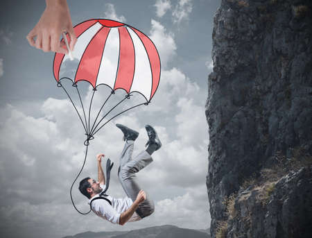 Businessman is saved from a fall deepの写真素材