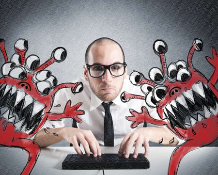 Businessman attempts to eradicate computer from virusesの写真素材