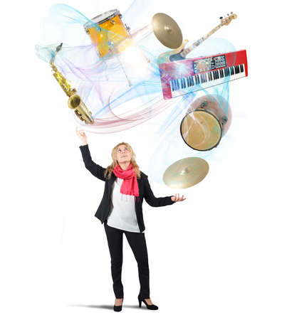 Woman plays with instruments like a jugglerの写真素材