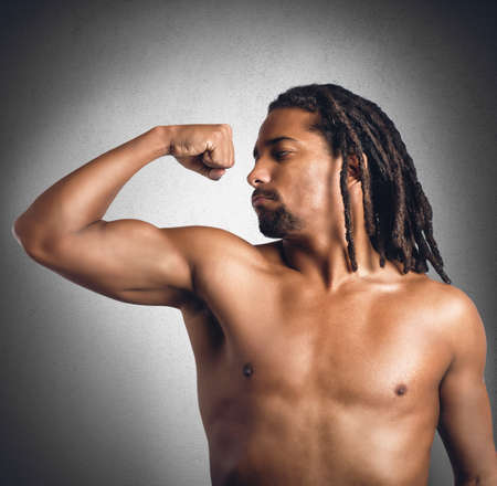 Hefty man looks proud his bulging bicepsの写真素材
