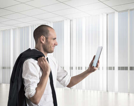 Businessman looks happy work results to mobileの写真素材