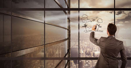 Businessman imagines holiday away from the cityの写真素材