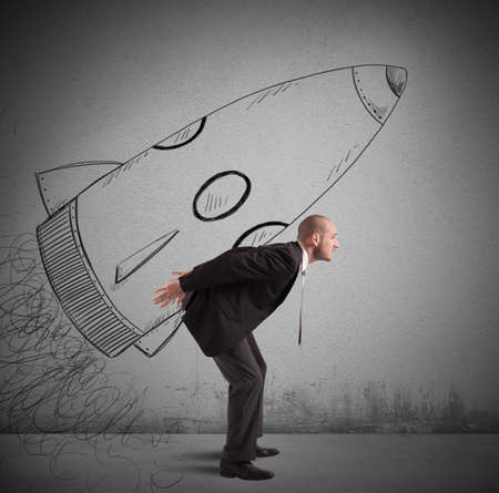 Businessman dreams to achieve success with spaceshipの写真素材