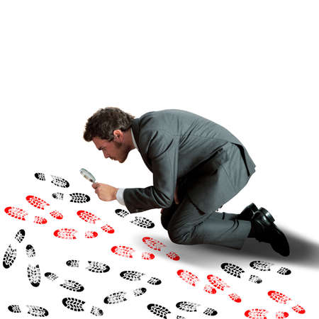 Man investigates and tries the different footprintsの写真素材