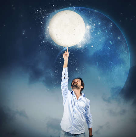 Man touch the sky with a fingerの写真素材