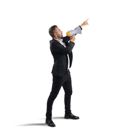 Businessman authoritarian orders at work from megaphoneの写真素材