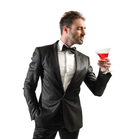Businessman in elegant dinner drinking his cocktailの写真素材