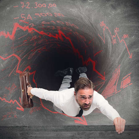 Businessman swallowed by the tunnel of debtsの写真素材