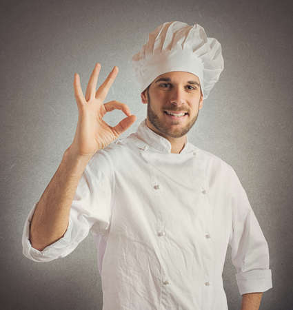 Confident and expert chef promotes his cuisineの写真素材