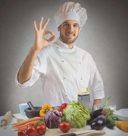Confident and expert chef promotes his cuisineの写真素材
