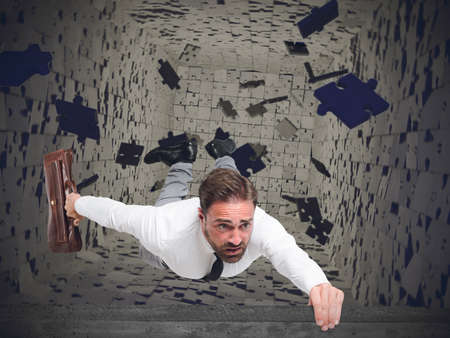 Businessman swallowed from instability and uncertainty fromの写真素材