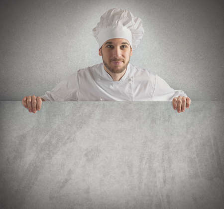 Chef showing his menu on a billboardの写真素材