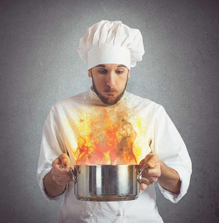 Chef blowing his burnt food in potの写真素材