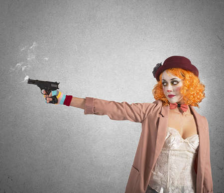 Clown thief shoots whit gun still smokingの写真素材