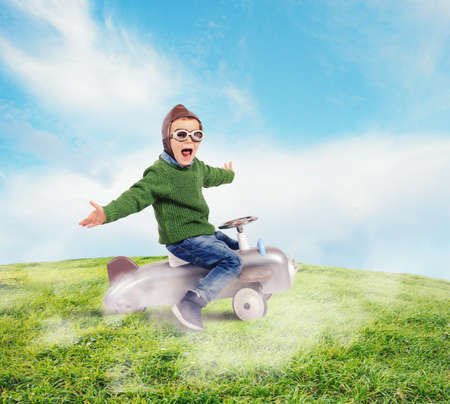 Cheerful boy kid playing at the aviatorの写真素材