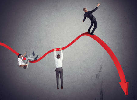 Businessmen falling down toward the economic crisisの写真素材