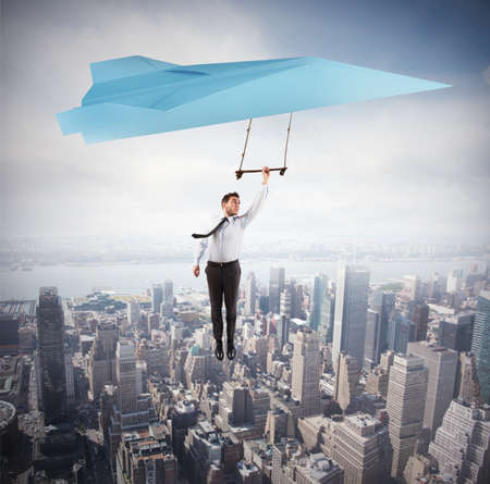 Businessman flying high above an urban landscape