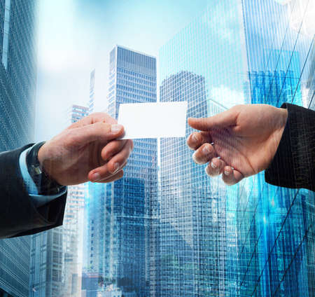 Passage of business card between business personの写真素材