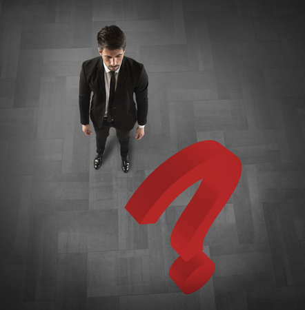 Businessman with a big red question markの写真素材