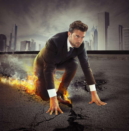 Determined businessman leaving fire trails on asphalt Determined businessman leaving fire trails on asphalt