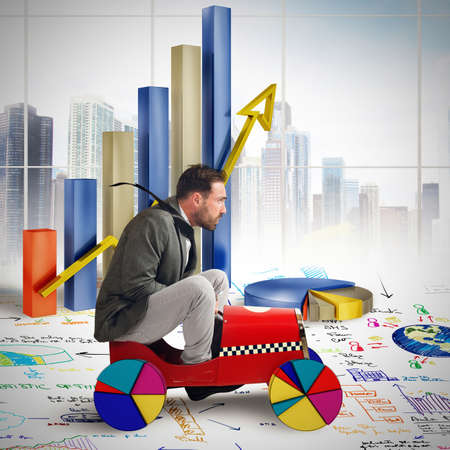 Businessman driving between growth diagrams and statisticsの写真素材