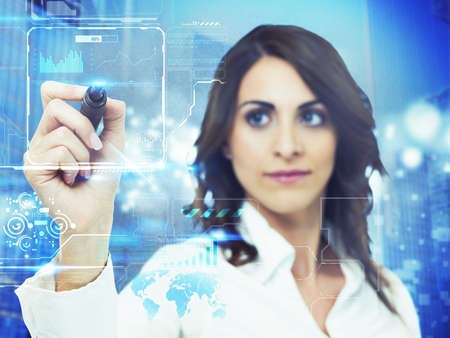 Businesswoman working in a futuristic computer interfaceの写真素材