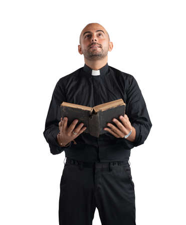 Priest praying and reading the sacred scriptureの写真素材