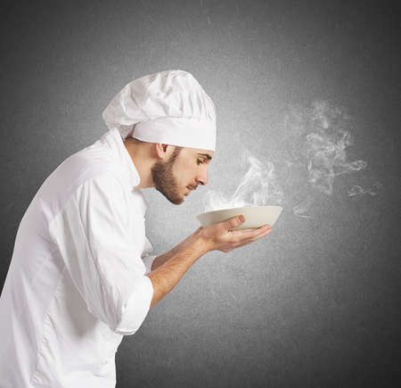 Man chef smelling the aroma of his dishの写真素材