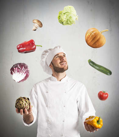 Chef plays with the vegetable as a jugglerの写真素材