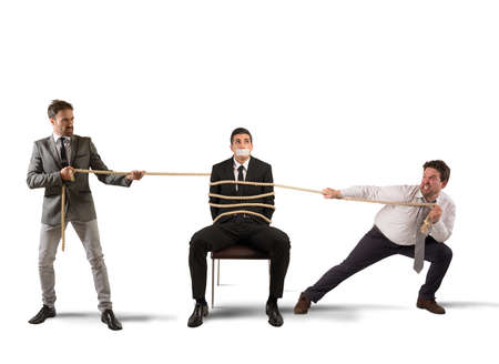 Businessmen hold tied one of their colleaguesの写真素材