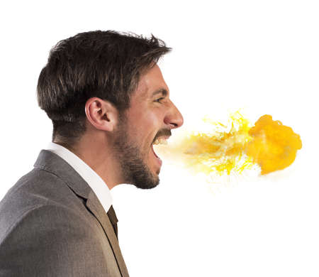 Aggressive businessman spits fire from his mouthの写真素材