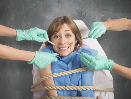 Girl tied to a chair at dentistの写真素材