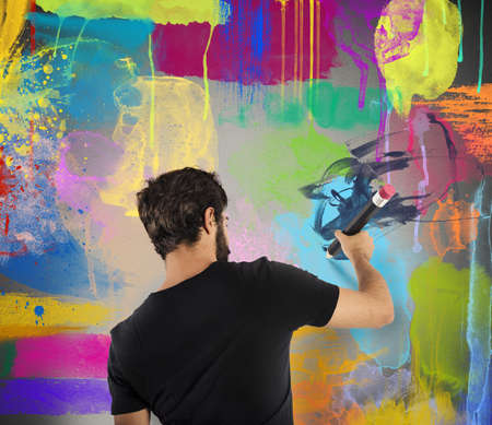 Creative boy colors with pencil a wallの写真素材