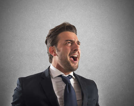 Business man pissed and furious at workの写真素材