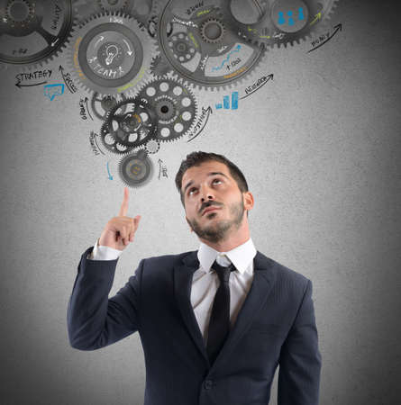 Businessman thought to a mechanism for ideaの写真素材