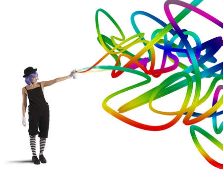 Woman clown with colored spray paints trailsの写真素材