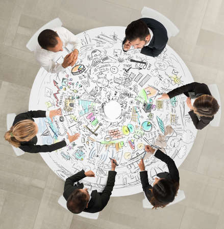 Work group design sitting around a tableの写真素材