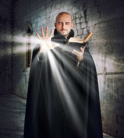 Priest with the Bible gives off lightの写真素材