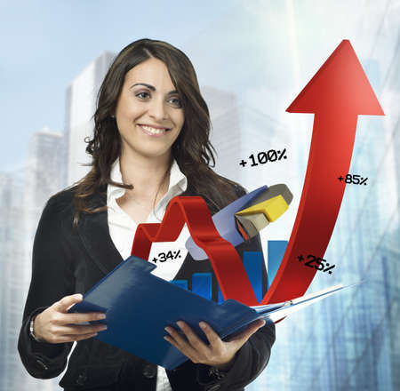 Businesswoman with statistical and financial charts notepadの写真素材