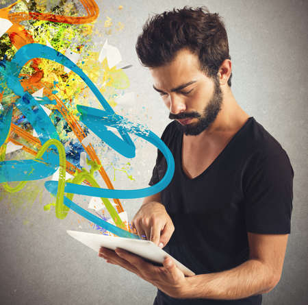 Boy touches tablet that has colors trails