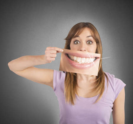 Girl shows her smile in a billboardの写真素材