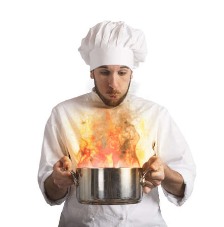 Chef blowing his burnt food in potの写真素材