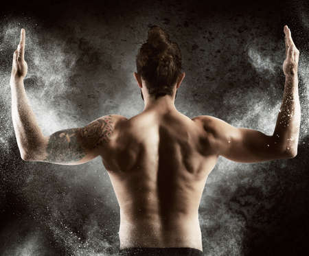 Muscle man shows off his muscular backの写真素材