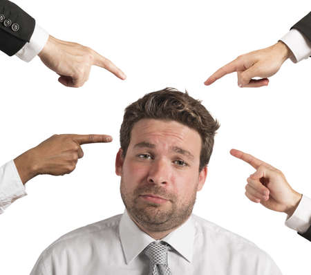 Businessman upset by the accusations of colleaguesの写真素材