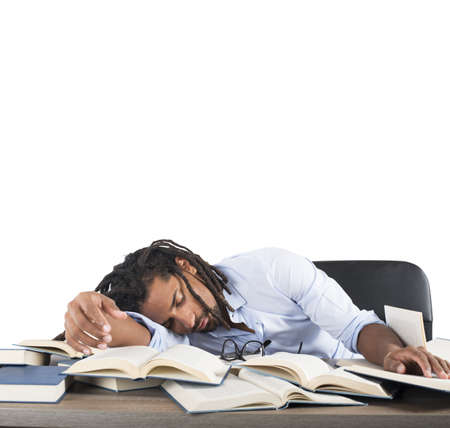 Tired teacher falls asleep while reading booksの写真素材