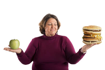 Woman undecided whether to start the dietの写真素材
