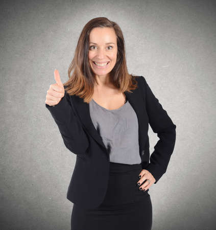 Portrait of positive businesswoman with thumb upの写真素材