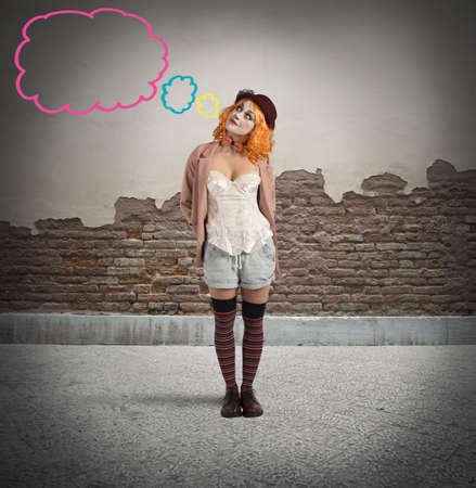 Malicious clown thinks with little colourful cloudsの写真素材