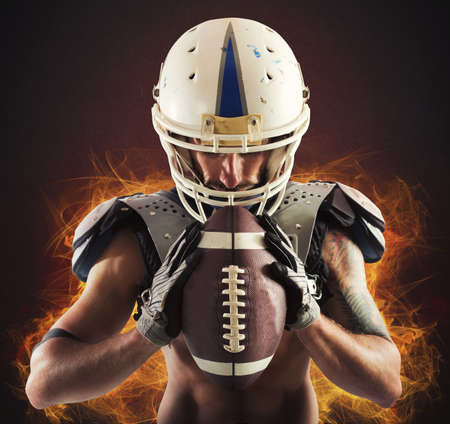 Football player holding ball in his handsの写真素材