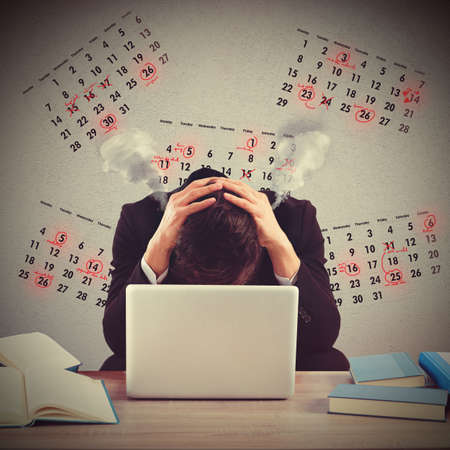 Businessman worried and stressed out by deadlinesの写真素材